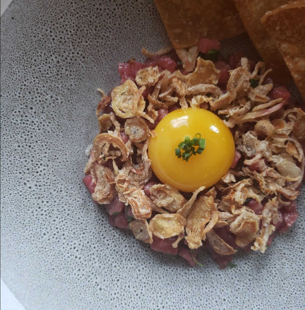 Wagyu beef tartar, nuoc cham, chili, fried onions, egg yolk, sour dough