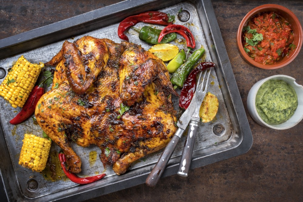 Chicken Under a Brick Adobe Stock